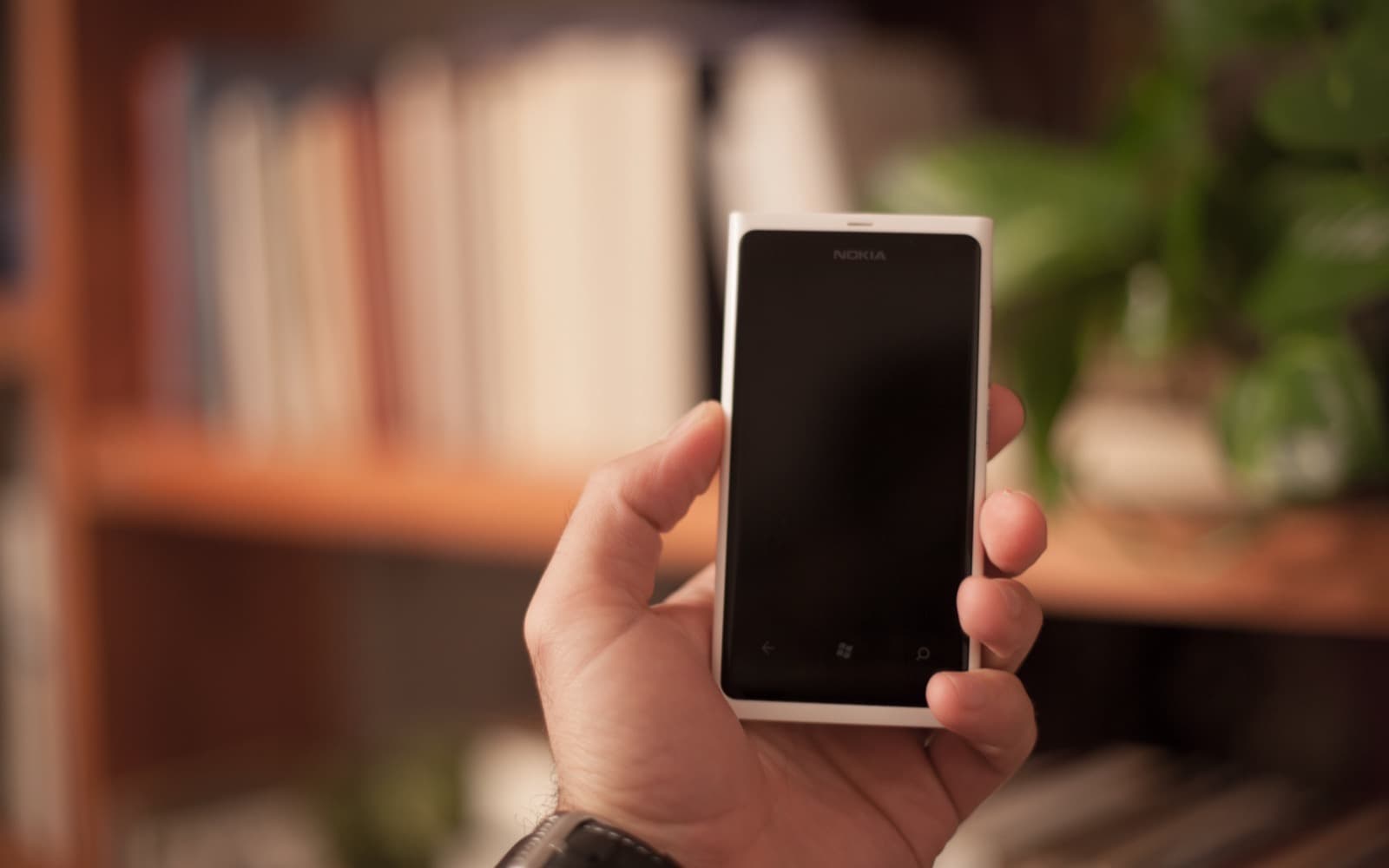 A consumer using a smartphone: telecoms, FMCG and electronics reach