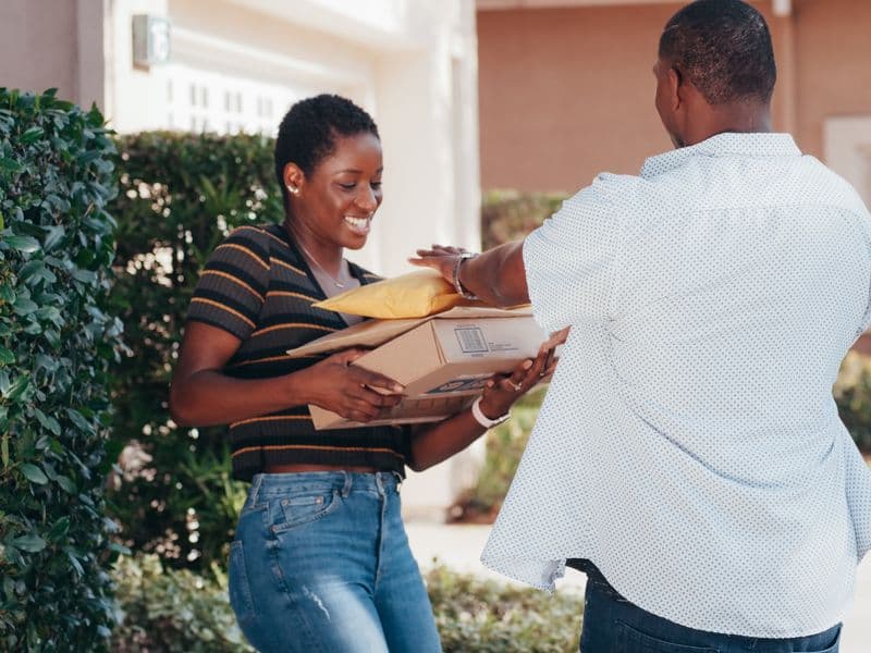 Customer receiving parcels from a delivery courier